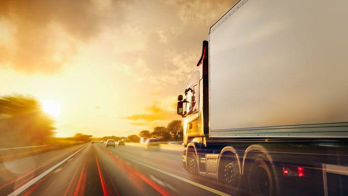 Truck driving down road