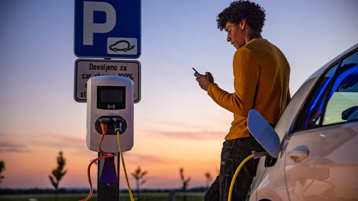 Man charging electric car