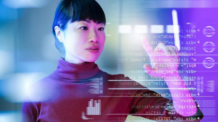 Person standing in front of wall displaying code