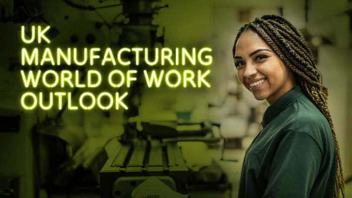 Person in workshop looking at the camera and smiling.